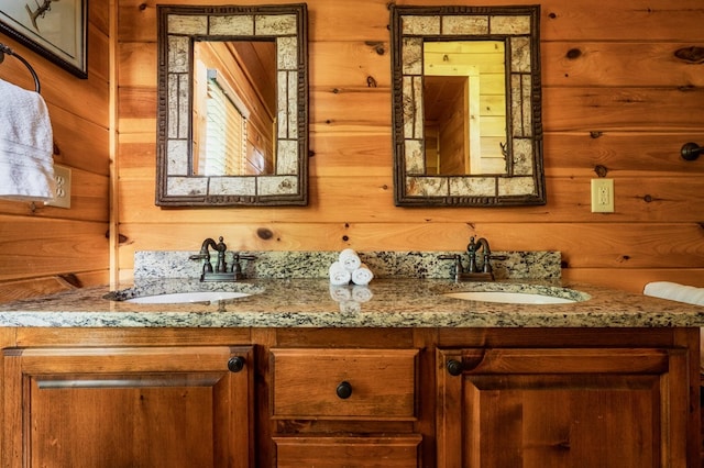 bathroom featuring vanity and wood walls