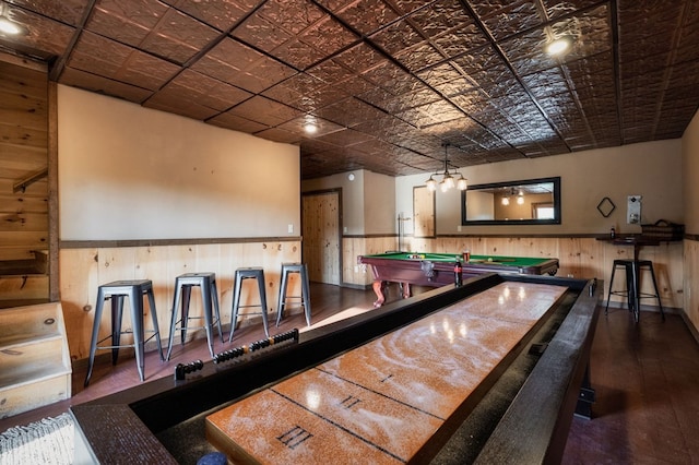 game room featuring dark wood-type flooring, pool table, and wooden walls