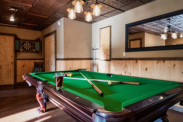 recreation room featuring wood-type flooring and wood walls