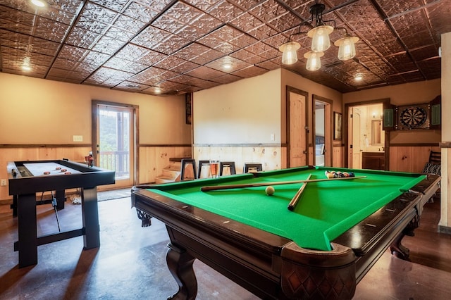 rec room with billiards, concrete floors, and wood walls