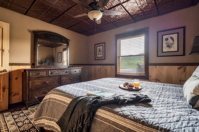 bedroom featuring wood walls