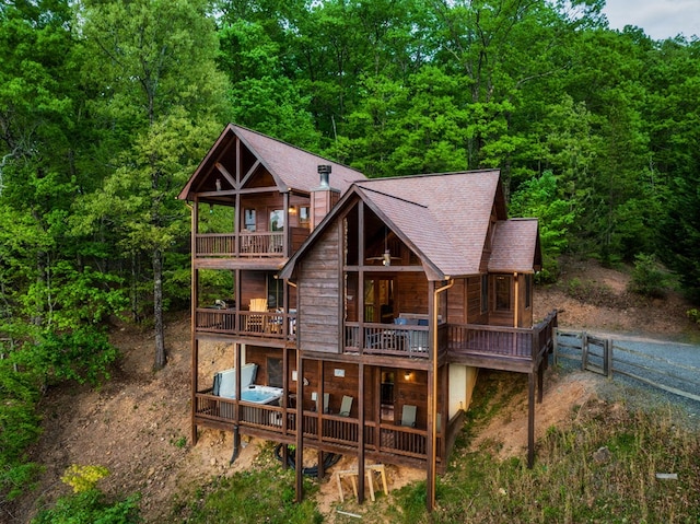 back of house featuring a balcony