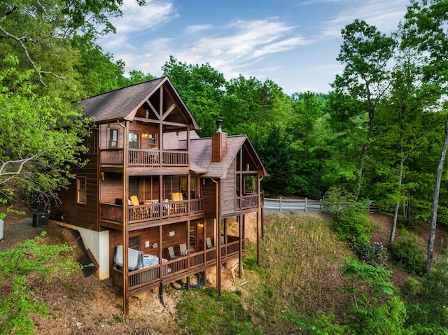 back of property with a balcony and central air condition unit