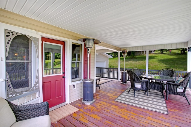 wooden terrace with outdoor dining space