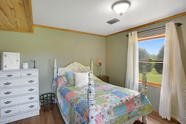 bedroom featuring visible vents and wood finished floors