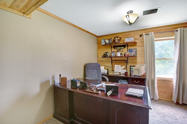 office featuring wooden walls, baseboards, light carpet, and visible vents