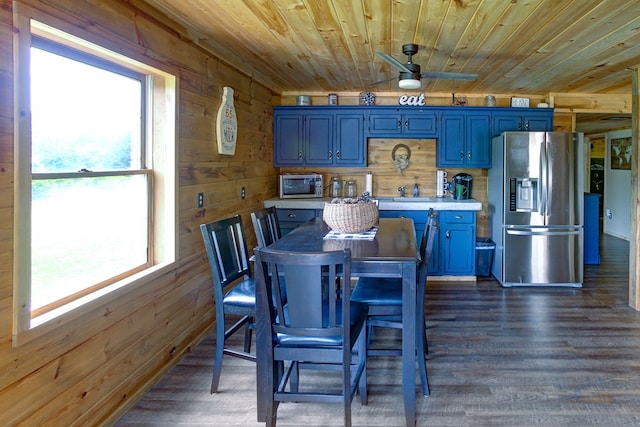 dining space with plenty of natural light, wood walls, and wood ceiling