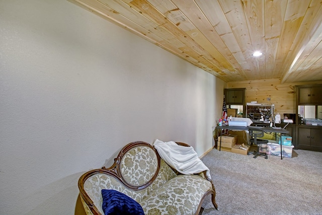 living area with carpet flooring, wood walls, recessed lighting, baseboards, and wooden ceiling