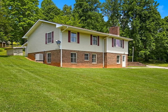 view of property exterior with a lawn, brick siding, and a chimney