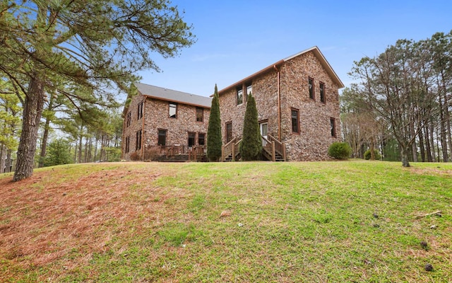 view of side of property with a lawn