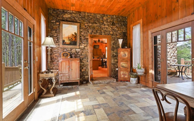 interior space with plenty of natural light, wood walls, and wooden ceiling