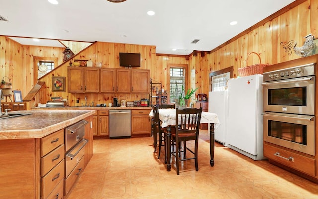 kitchen with stainless steel appliances, a center island, and crown molding