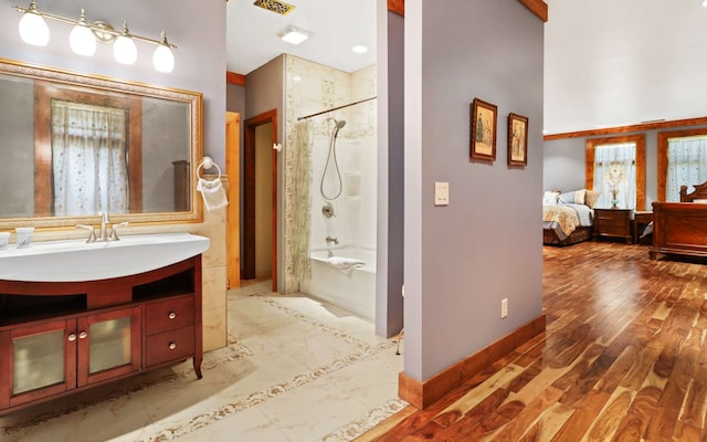 bathroom with tiled shower / bath combo, oversized vanity, and tile floors