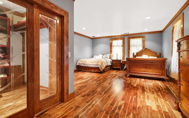 bedroom featuring crown molding and hardwood / wood-style floors