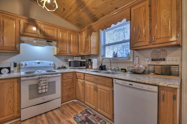 kitchen featuring lofted ceiling, white appliances, sink, light hardwood / wood-style floors, and light stone counters