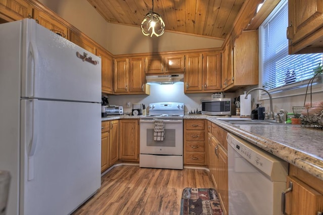 kitchen with pendant lighting, white appliances, sink, vaulted ceiling, and light wood-type flooring