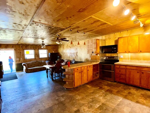 37 Shady Creek Rdg, Marble, NC 28905 - kitchen featuring a ceiling fan, a peninsula, range with two ovens, black microwave, and open floor plan