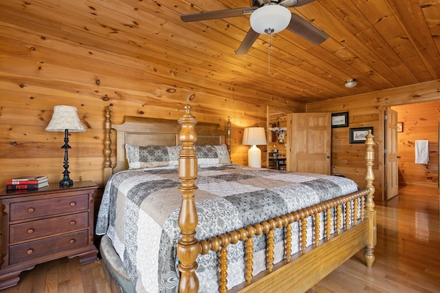 bedroom with wood walls, wooden ceiling, and wood finished floors