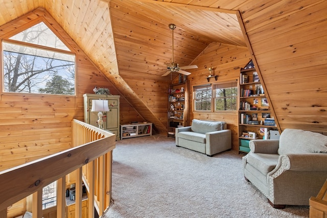 sitting room featuring a ceiling fan, carpet, wooden walls, lofted ceiling, and wood ceiling