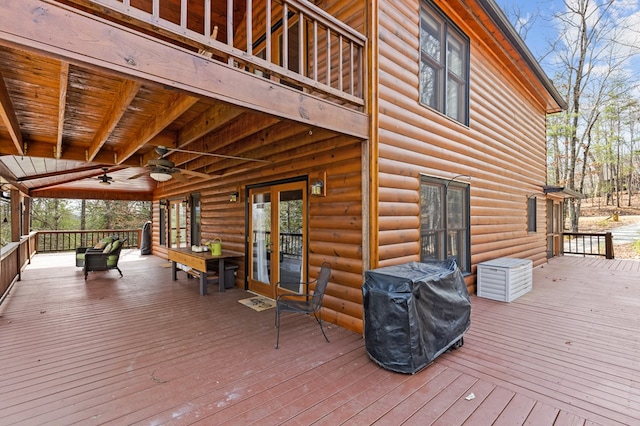 wooden terrace with area for grilling, french doors, and a ceiling fan