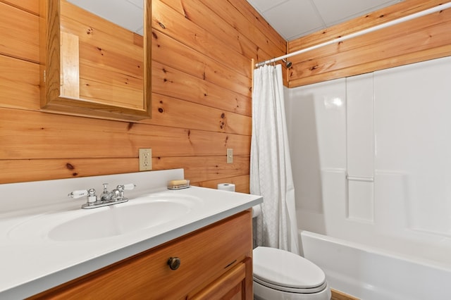 full bath with shower / bath combo with shower curtain, vanity, toilet, and wooden walls