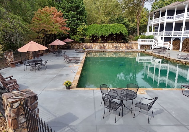 view of swimming pool with a patio area