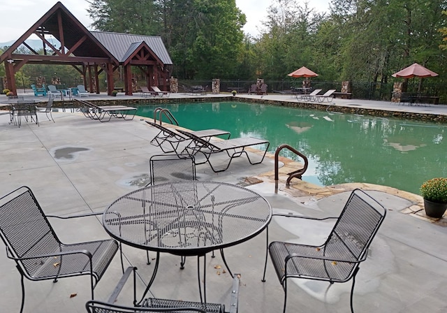 view of pool with a gazebo and a patio area