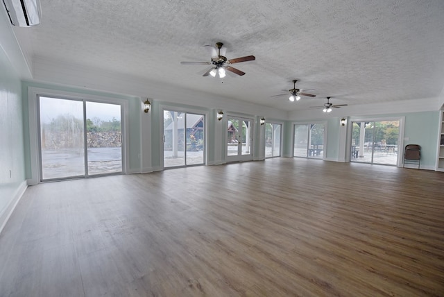 unfurnished living room with ceiling fan, a healthy amount of sunlight, and light wood-type flooring