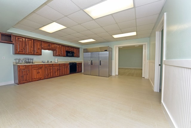 kitchen featuring a paneled ceiling, built in fridge, and sink