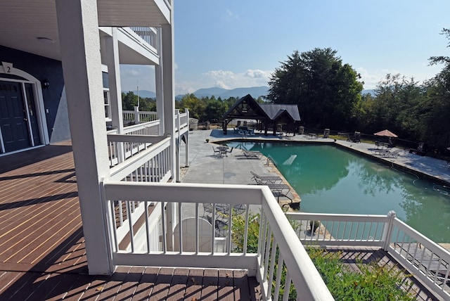 view of swimming pool featuring a mountain view and a patio