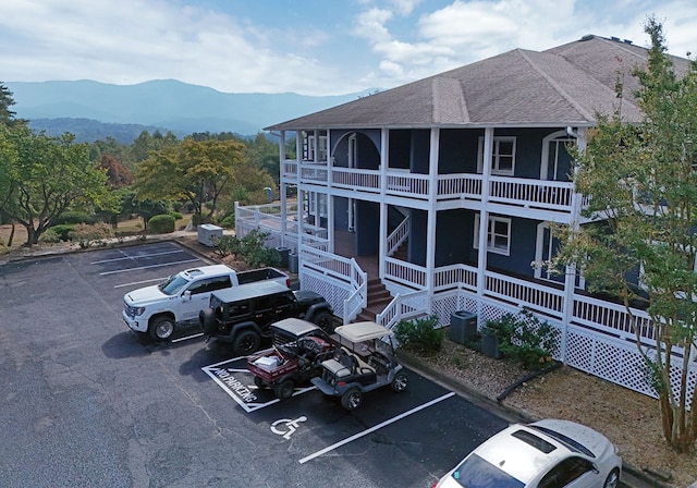 view of building exterior featuring a mountain view and cooling unit