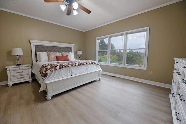 bedroom featuring ceiling fan, crown molding, a textured ceiling, and light wood-type flooring