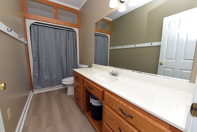 bathroom with hardwood / wood-style floors, vanity, toilet, and crown molding