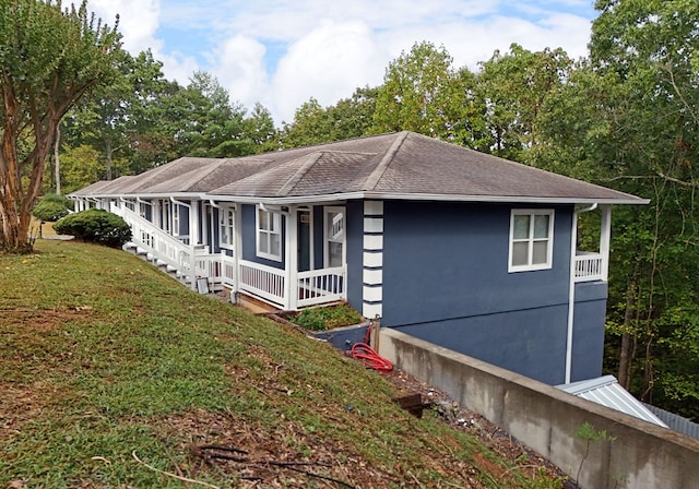 view of side of property with a yard