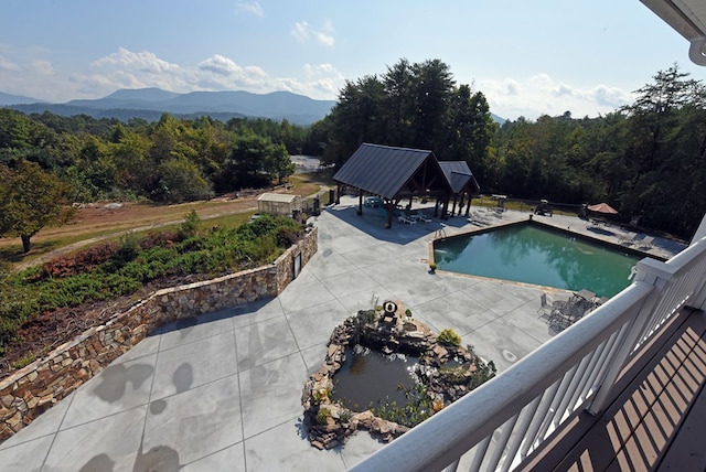 view of pool with a gazebo and a mountain view