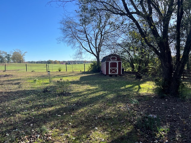 view of yard featuring a storage unit and a rural view