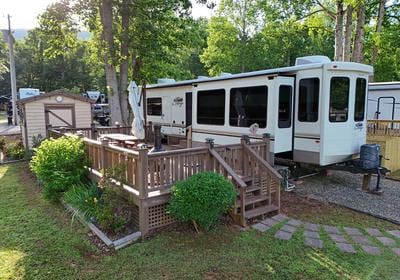 back of property with a shed and a deck