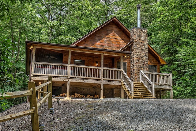 log cabin featuring ceiling fan