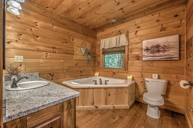 bathroom with wooden ceiling, wood walls, wood-type flooring, toilet, and a bathtub