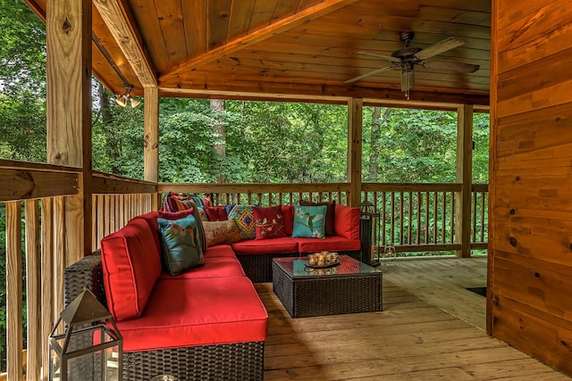 wooden terrace featuring outdoor lounge area and ceiling fan