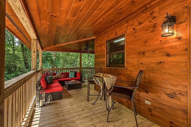 deck with an outdoor living space and ceiling fan