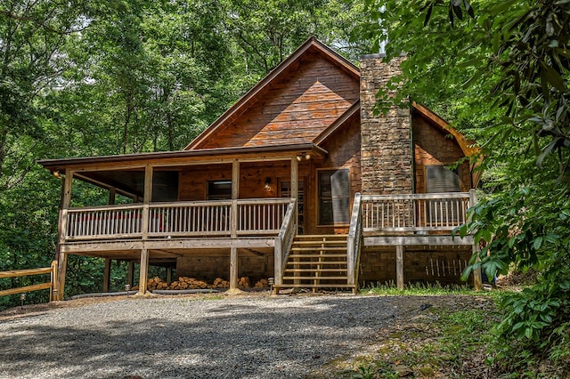 log-style house with covered porch