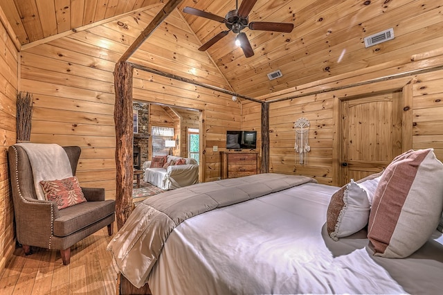 bedroom with wood walls, high vaulted ceiling, wooden ceiling, and hardwood / wood-style flooring