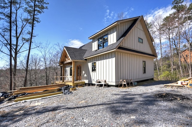view of side of home featuring roof with shingles and board and batten siding
