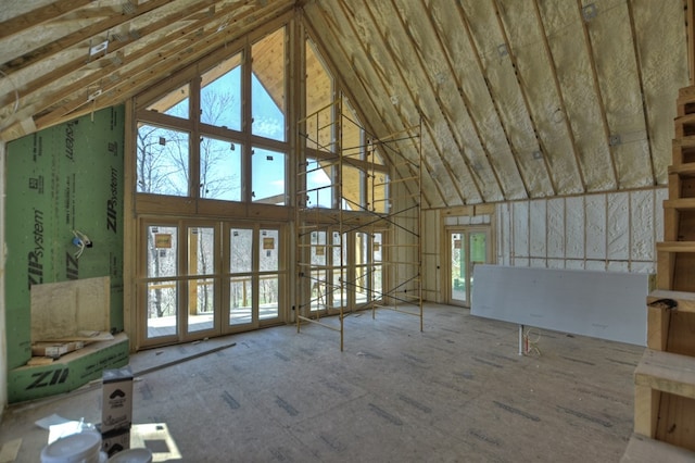 unfurnished living room featuring high vaulted ceiling