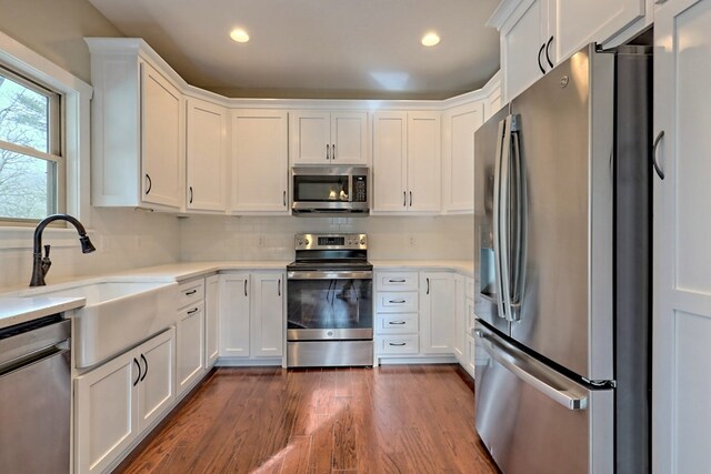 unfurnished room with a chandelier, dark hardwood / wood-style floors, vaulted ceiling, and a healthy amount of sunlight