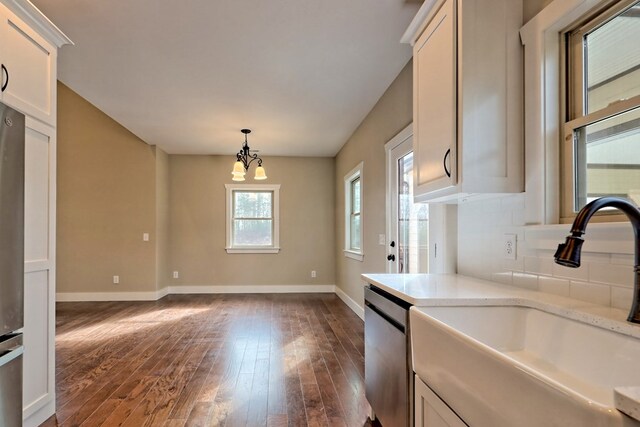 kitchen with white cabinets, dark wood-type flooring, a healthy amount of sunlight, and stainless steel appliances