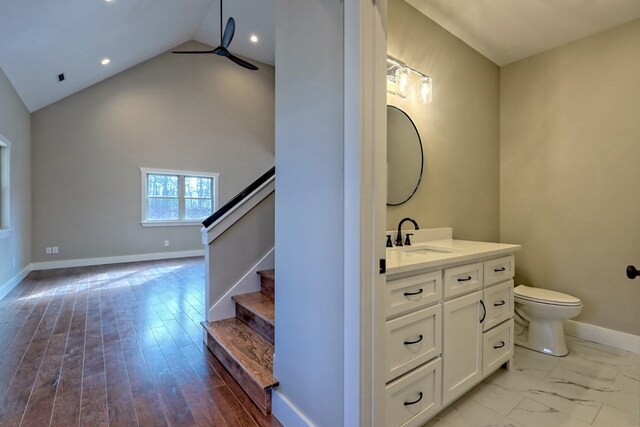 empty room with dark hardwood / wood-style flooring, ceiling fan, and a healthy amount of sunlight