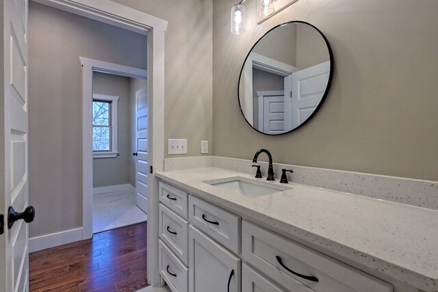 bathroom featuring vanity, hardwood / wood-style flooring, toilet, and lofted ceiling