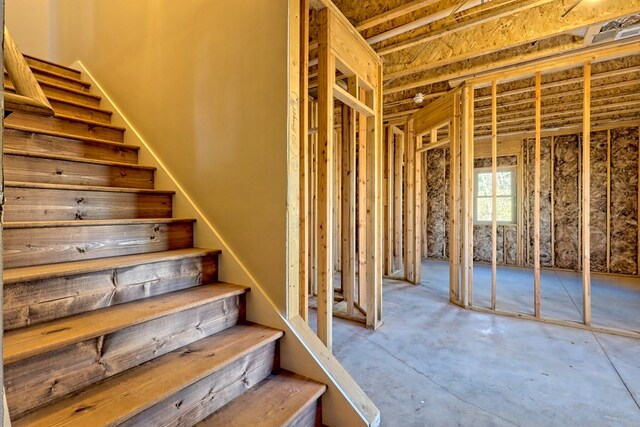 staircase featuring wood-type flooring, high vaulted ceiling, a wealth of natural light, and ceiling fan